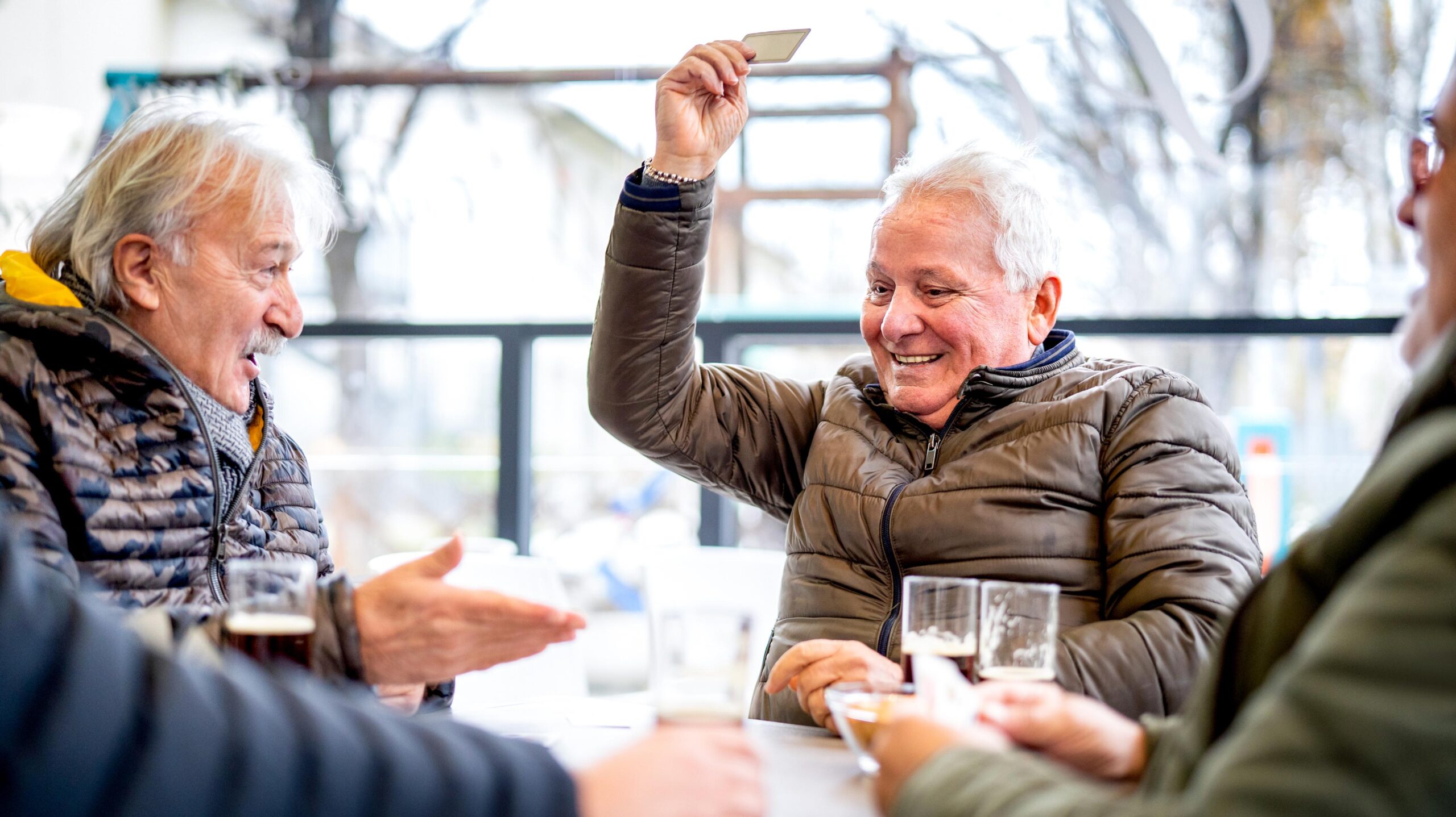 Man playing cards enthusiastically